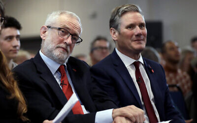 Jeremy Corbyn, left, sits waiting to speak next to Keir Starmer during their election campaign event on Brexit in Harlow, England, November 5, 2019. (AP Photo/Matt Dunham)