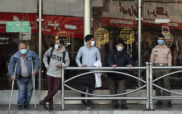People wear protective face masks to help prevent the spread of the coronavirus in downtown Tehran, Iran, October 11, 2020. (Ebrahim Noroozi/AP)
