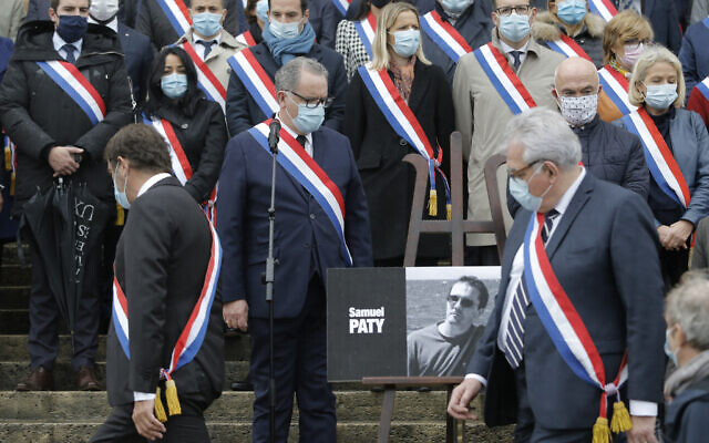 French lawmakers gather to pay homage to slain teacher Samuel Paty on October 20, 2020 on the steps of the National Assembly in Paris. (AP/Lewis Joly)