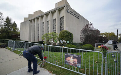 A man places flowers outside the Tree of Life synagogue in Pittsburgh on October 27, 2020, the second anniversary of the shooting at the synagogue that killed 11 worshipers. (Gene J. Puskar/AP)