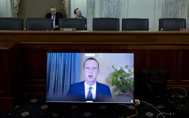 Facebook CEO Mark Zuckerberg appears on a screen as he speaks remotely during a hearing before the Senate Commerce Committee on Capitol Hill, October 28, 2020, in Washington (Michael Reynolds/Pool via AP)