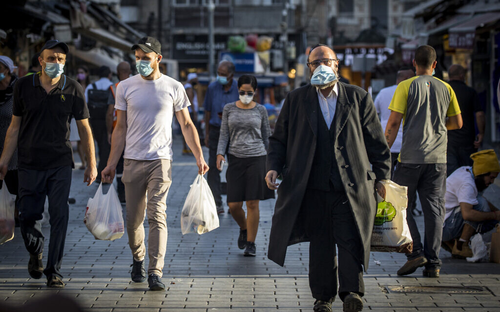 Illustrative: People wear face masks at the Mahane Yehuda market in Jerusalem on September 30, 2020, during a nationwide lockdown to prevent the spread of COVID-19. (Olivier Fitoussi/Flash90)
