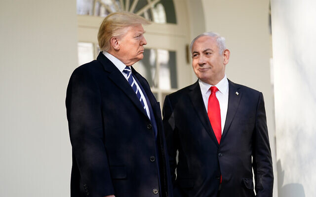 Then-US president Donald Trump, left, and Prime Minister Benjamin Netanyahu walk to a meeting in the Oval Office of the White House, January 27, 2020. (AP Photo/ Evan Vucci)