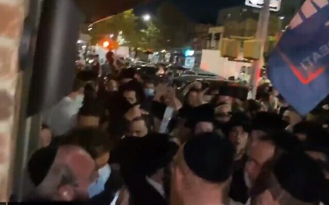 Jewish Insider reporter Jacob Kornbluh (bottom left) is surrounded by dozens of ultra-Orthodox protesters in Brooklyn, New York, on October 7, 2020. (screencapture/ Twitter)