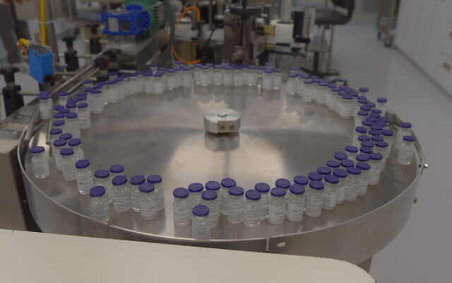 Vials of a potential coronavirus vaccine are seen on an assembly line in a photograph released by the Israel Institute for Biological Research on October 25, 2020. (Defense Ministry)
