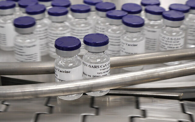 Vials of a potential coronavirus vaccine are seen on an assembly line, in a photograph released by the Israel Institute for Biological Research, on October 25, 2020. (Defense Ministry)