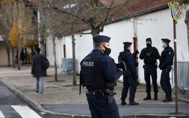 Illustrative: French CRS (Compagnies Republicaines de Securite) police officers stand near the entrance of Le Bois d'Aulne middle school in Conflans-Sainte-Honorine, northwest of Paris, on November 3, 2020 (Thomas COEX / AFP)