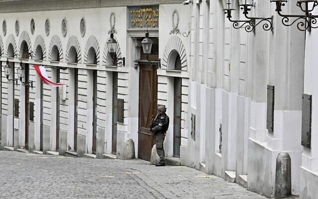 An armed policeman stands guard in front of the synagogue in Seitenstettengasse in Vienna on November 3, 2020, one day after the shootings nearby and at multiple locations across central Vienna. (Hans Punz/APA/AFP)