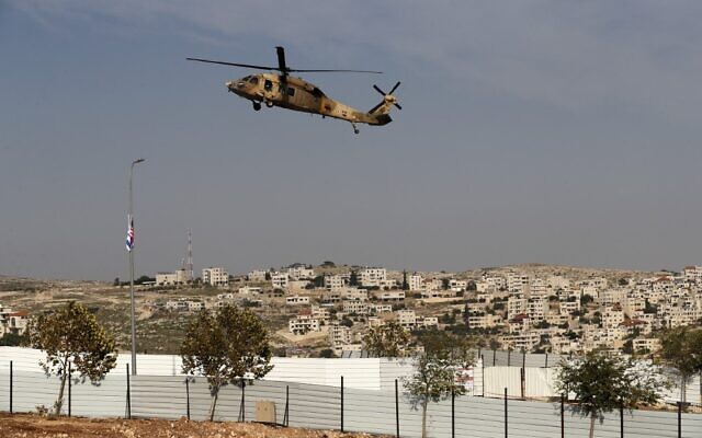 An Israeli airforce Blackhawk helicopter carrying US Secretary of State Mike Pompeo hovers over Sha'ar Binyamin industrial park near the Psagot settlement in the West Bank, north of Jerusalem, on November 19, 2020. (Ahmad GHARABLI/AFP)