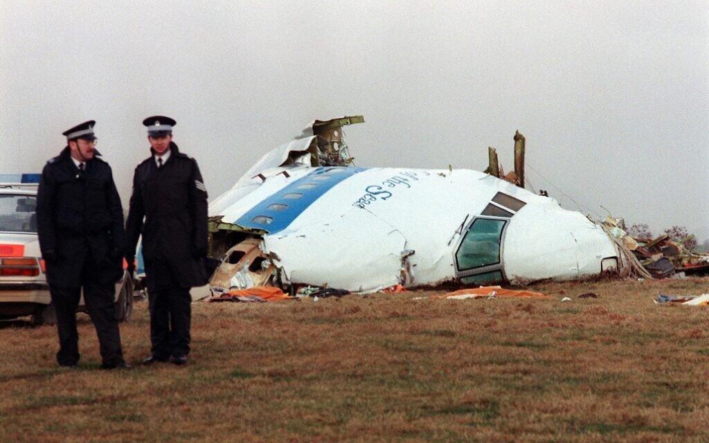 Hours after the event, policemen stand near the wreckage of the 747 Pan Am airliner that exploded and crashed over Lockerbie, Scotland, on December 21, 1988. (Roy Letkey/AFP)