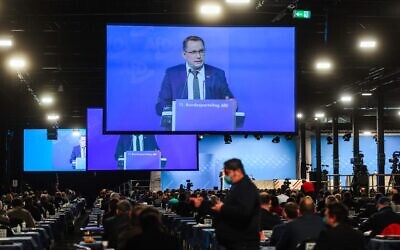 Tino Chrupalla, Federal Spokesperson, is seen on video screens during his speech at the Party Congress of farright AfD party at the Wunderland Kalkar, western Germany, on November 28, 2020. (INA FASSBENDER / AFP)