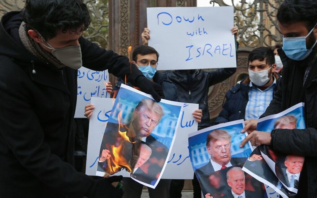 Students of Iran's Basij paramilitary force burn posters depicting US President Donald Trump (top) and President-elect Joe Biden, during a rally in front of the foreign ministry in Tehran, on November 28, 2020, to protest the killing of prominent nuclear scientist Mohsen Fakhrizadeh a day earlier near the capital. (Atta Kenare/AFP)