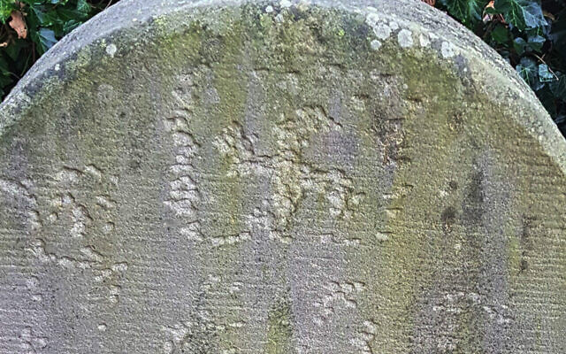 A swastika carved into a headstone at the Jewish cemetery of Haren, Germany in November 2020. (Courtesy of the Jewish Community of Haren/Eli Nahum/Monitoring Antisemitism Worldwide via JTA)