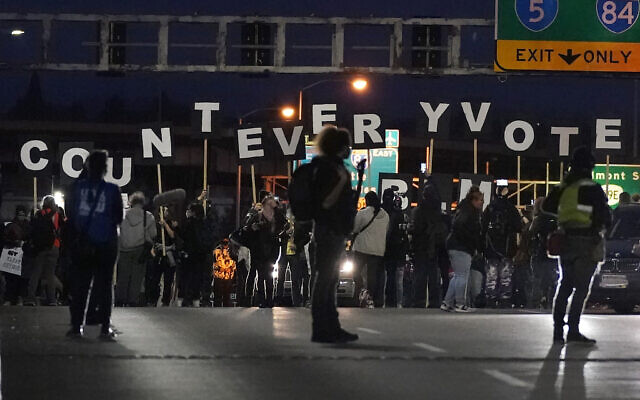 Protesters hold letters that spell Count Every Vote as they cross an overpass while marching in Portland, Oregon, November 4, 2020. (AP Photo/Marcio Jose Sanchez)