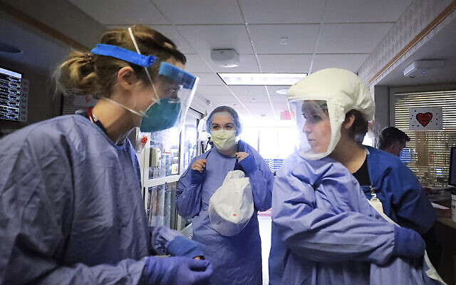 In this Nov. 5, 2020, file photo, medical staff attending to patients with COVID-19 wear protective equipment in a unit dedicated to treatment of the coronavirus at UW Health in Madison, Wis. Conditions inside the nation’s hospitals are deteriorating by the day as the coronavirus rages through the country at an unrelenting pace. (John Hart/Wisconsin State Journal via AP, File)