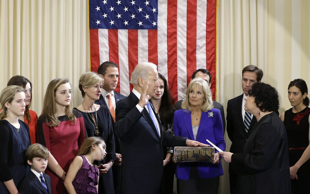 File: Then-US Vice President Joe Biden, with his wife Jill Biden holding the Biden Family Bible, takes the official oath of office from Supreme Court Justice Sonia Sotomayor, surrounded by family, during an official ceremony at the Naval Observatory, January 20, 2013, in Washington. (AP Photo/Carolyn Kaster)