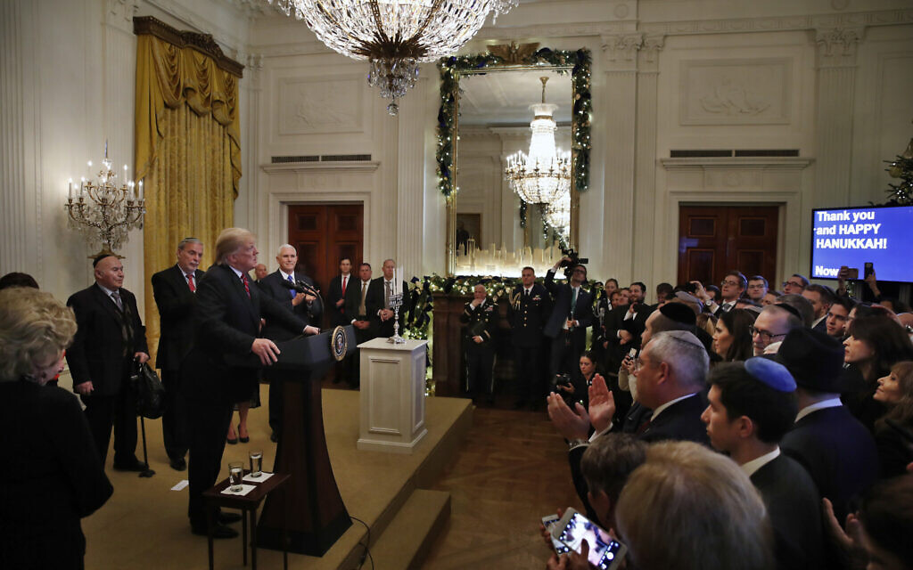 People in the audience applaud as US President Donald Trump speaks during a Hanukkah reception on December 6, 2018, in the East Room of the White House in Washington. (AP/Jacquelyn Martin)