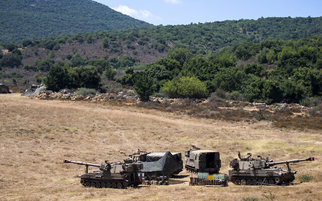 Israeli soldiers sit in a tent next to their mobile artillery piece near the border with Lebanon, northern Israel, August 26, 2020. (AP/Ariel Schalit)