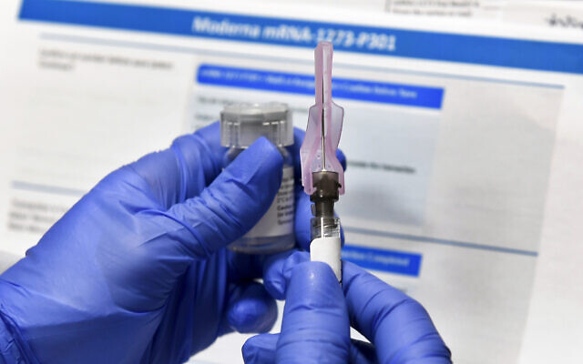 A nurse prepares a shot as a study of a possible COVID-19 vaccine, developed by the National Institutes of Health and Moderna Inc., gets underway in Binghamton, New York, on July 27, 2020. (AP Photo/Hans Pennink)