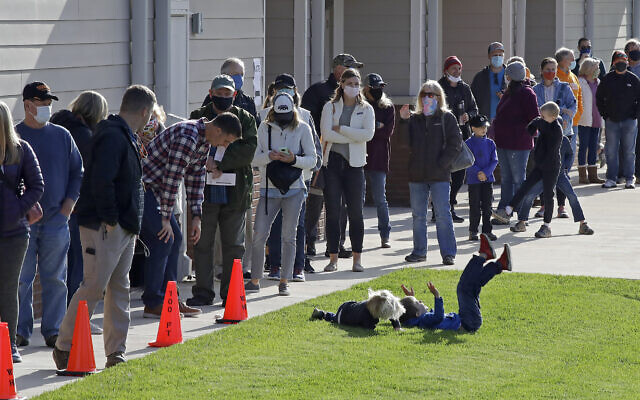 Children play as voters wait in line to cast their ballots at Waldens Ridge Emergency Services building on Election Day, Nov. 3, 2020, in Walden, Tennessee. (AP/Ben Margot)