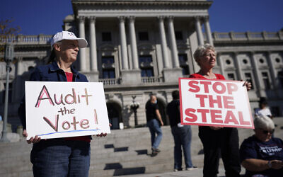 People demonstrate outside the Pennsylvania State Capitol, Friday, November 6, 2020, in Harrisburg, Pennsylvania, as vote counting continued. (AP Photo/Julio Cortez)