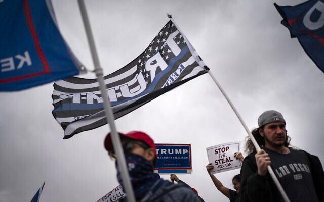 Supporters of President Donald Trump stand outside of the Clark County Elections Department in North Las Vegas, Saturday, November 7, 2020. (AP Photo/Wong Maye-E)