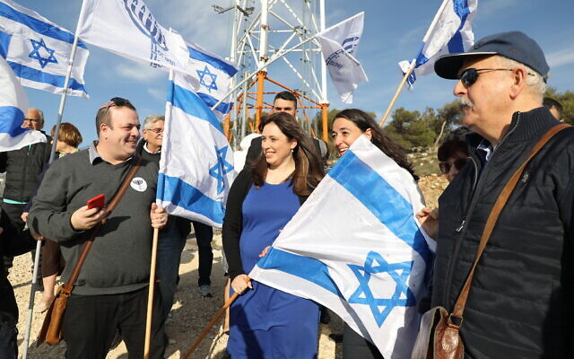 Likud supporters hold flags near then-minister of Diaspora Affairs Tzipi Hotovely at a demonstration demanding Israeli sovereignty over the West Bank, February 27, 2020 (Gershon Elinson/Flash90)