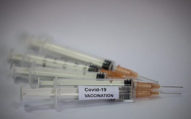 Illustrative: Syringes labeled as containing COVID-19 vaccinations in Jerusalem, November 16, 2020. (Yonatan Sindel/Flash90)