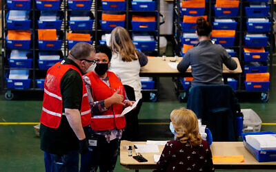 Election workers check mail-in and absentee ballots for the 2020 General Election in West Chester, Pennsylvania, Nov. 3, 2020. (AP Photo/Matt Slocum)