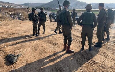 Israeli soldiers stand at the scene of what the military says was an attempted stabbing attack outside the al-Fawwar refugee camp in the southern West Bank on November 8, 2020. (Israel Defense Forces)