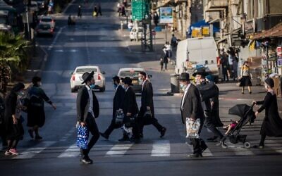 Ultra-Orthodox Jews cross the road at the Bar-Ilan junction in Jerusalem, on October 19, 2020. (Yonatan Sindel/Flash90)