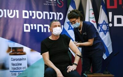 Health Minister Yuli Edelstein receives a coronavirus vaccine at Sheba Medical Center in Ramat Gan, on December 19, 2020. (Amir Cohen/Pool/AFP)