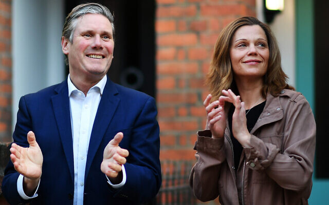 Labour leader Keir Starmer and his wife Victoria applaud outside their home on May 14, 2020 in London, England (Justin Setterfield/Getty Images via JTA)