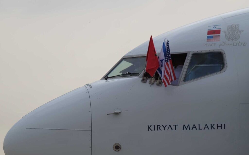 The national flags of Morocco, Israel and the United States on an El Al plane to Morocco flying a delegation to finalize a normalization deal between Jerusalem and Rabat, at Ben Gurion airport, near Tel Aviv, December 22, 2020. (Judah Ari Gross/Times of Israel)