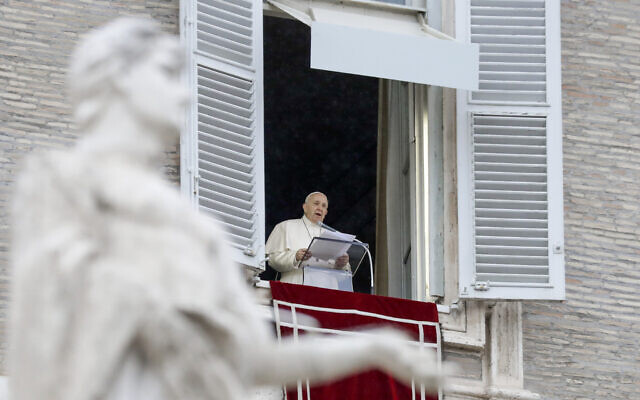 Pope Francis delivers his blessing as he recites the Angelus noon prayer from the window of his studio overlooking St. Peter's Square, at the Vatican, December 6, 2020. (AP Photo/Andrew Medichini)