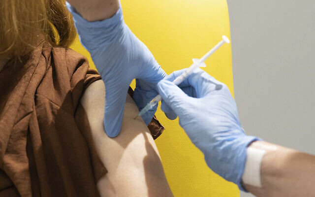 Undated file photo shows a volunteer receiving the coronavirus vaccine developed by AstraZeneca and Oxford University, in Oxford, England. (John Cairns/University of Oxford via AP, File)