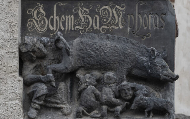 The so-called "Judensau," or "Jew pig," sculpture is displayed on the facade of the Stadtkirche (Town Church) in Wittenberg, Germany, Jan. 14, 2020. (AP Photo/Jens Meyer, File )