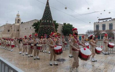 Palestinian scout bands parade through Manger Square at the Church of the Nativity in the West Bank city of Bethlehem, Thursday, Dec. 24, 2020 (AP Photo/Nasser Nasser)