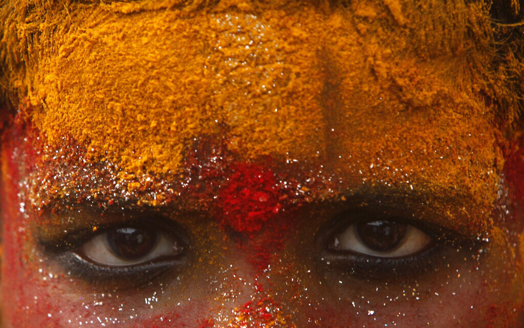 Illustrative: A young devotee, face smeared with turmeric powder, participates in a procession towards Golconda Fort during Bonalu festival in Hyderabad, India, July 15, 2010. (AP Photo/Mahesh Kumar A.)