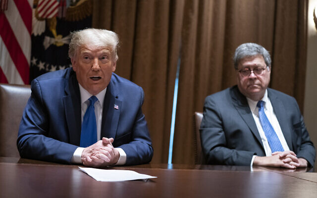Then-US Attorney General William Barr listens as then-US president Donald Trump speaks during a meeting with Republican state attorneys general in the Cabinet Room of the White House in Washington, September 23, 2020. (AP Photo/Evan Vucci, File)