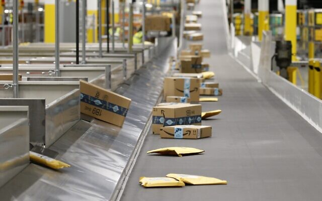 Illustrative: Amazon packages move along a conveyor at an Amazon warehouse facility in Goodyear, Arizona, December 17, 2019. (AP Photo/Ross D. Franklin, File)