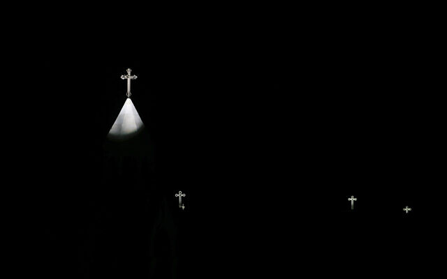 Crosses are lit on the Church of the Nativity, traditionally believed by Christians to be the birthplace of Jesus Christ, during the Christmas tree lightning ceremony in the West Bank city of Bethlehem, Saturday, Dec. 5, 2020. (AP Photo/Majdi Mohammed)