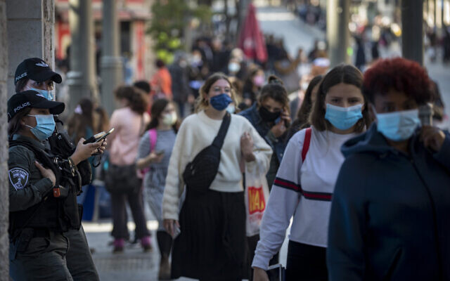 People wearing a face mask walk in the Jerusalem city center on November 29, 2020, as Israel steps out of its coronavirus lockdown and rolls back restrictions. (Olivier Fitoussi/Flash90)