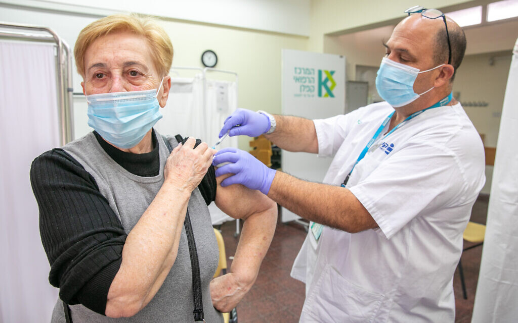 A woman receives a COVID-19 vaccine at a Clalit vaccination center in Rehovot on December 29, 2020. (Yossi Aloni/Flash90)