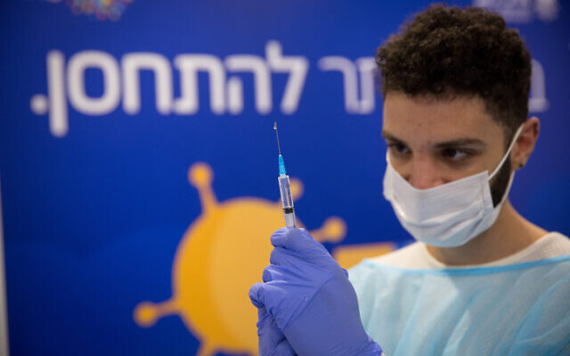 File: A nurse prepares a vaccine at Rabin Square in Tel Aviv, December 31, 2020. (Miriam Alster/Flash90)