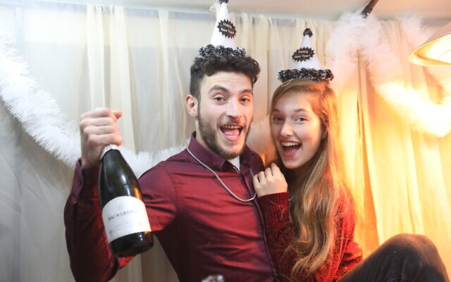 An Israeli couple celebrates New Year's Eve, in central Israel, December 31, 2020. (Yossi Aloni/FLASH90)