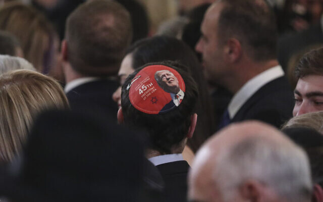 An attendee wears a yarmulke with an image of US President Donald Trump at a Hanukkah reception in the East Room of the White House on December 6, 2018, in Washington, DC. (Oliver Contreras-Pool/Getty Images via JTA)