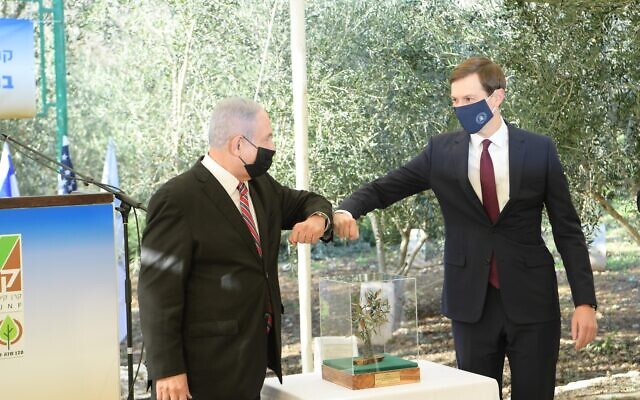 Prime Minister Benjamin Netanyahu (L) and White House senior adviser Jared Kushner after planting an olive tree at the Jerusalem Grove of Nations on December 21, 2020. (Amos Ben Gershom/ GPO)