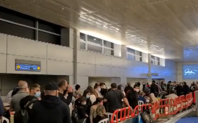 Israelis who had returned from Dubai queue to receive exemptions from hotel quarantine at Ben Gurion Airport, December 28, 2020. (Screen Capture: Channel12)
