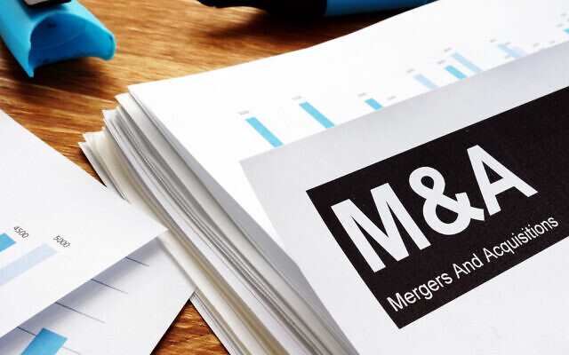 An illustrative image of a merger and acquisition deal (designer491; iStock by Getty Images)
